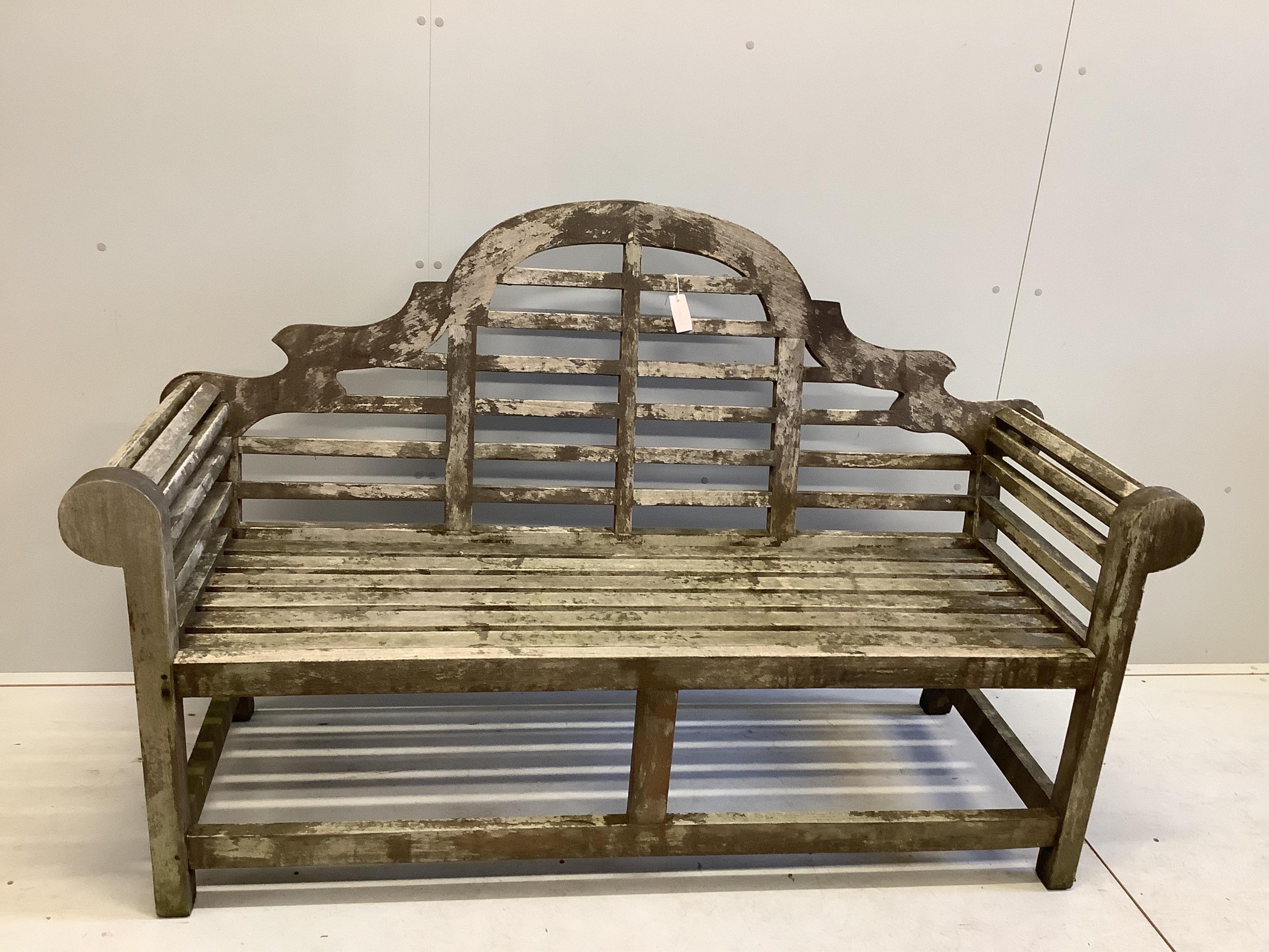 A Lutyens style weathered teak garden bench, width 165cm, depth 57cm, height 104cm. Condition - fair